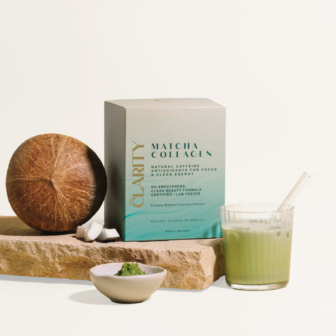 CLARITY Matcha Collagen Go - Bild mit Kokosnuss, Matcha und Matcha Kollagen Glaß. 